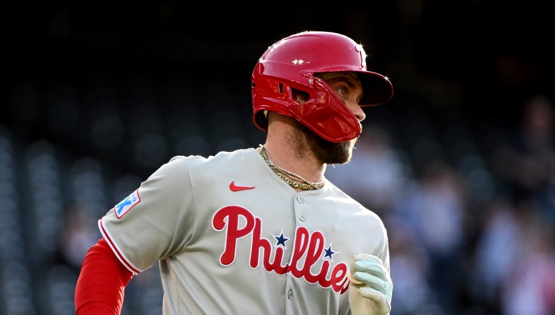 Philadelphia Phillies' Bryce Harper (3) runs to first base on a single in the first inning of a baseball game against the Colorado Rockies, Wednesday, May 21, 2025, in Denver. (AP Photo/Geneva Heffernan)