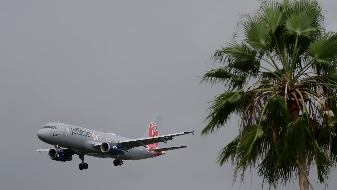 JetBlue's Red Sox-themed Plane arrives at the Luis Muñoz Marin airport with Manager Alex Cora, players, coaches and executive staff to celebrate the team's 2018 championship season victory, in Carolina, Puerto Rico, Saturday, Nov. 3, 2018.