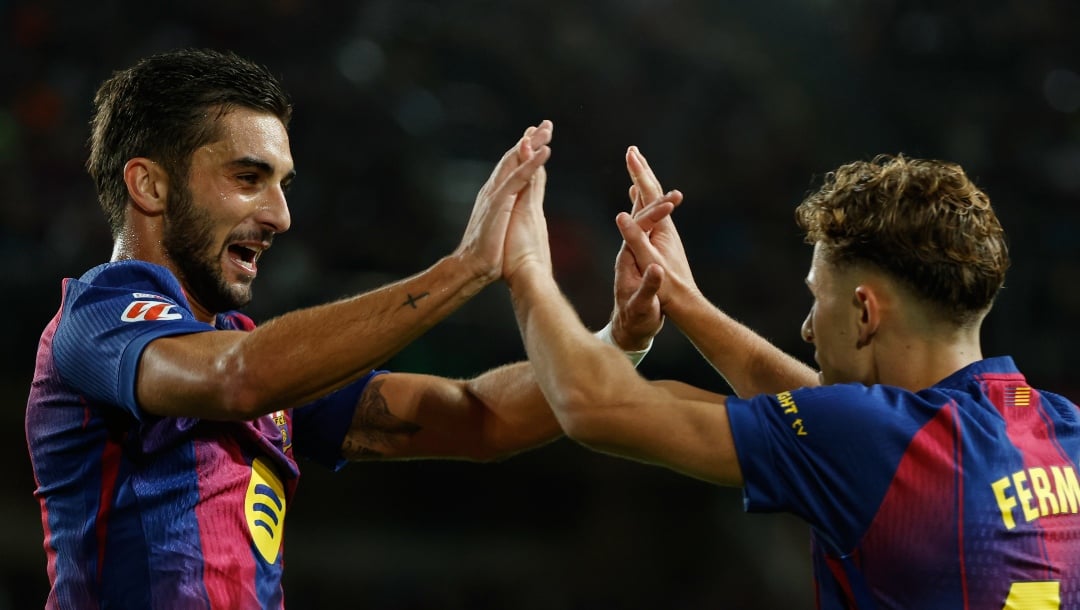 Barcelona's Ferran Torres, left, celebrates with his teammate Fermin Lopez after scoring his side's second goal during a Spanish La Liga soccer match between FC Barcelona and Elche CF in Barcelona, Spain, Sunday, Nov. 2, 2025. (AP Photo/Joan Monfort)