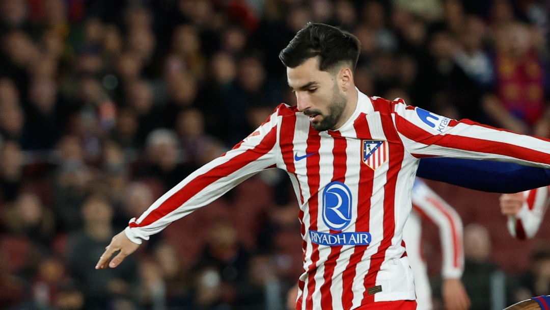 Barcelona's Raphinha fights for the ball against Atletico Madrid's Alex Baena during a Spanish La Liga soccer match between Barcelona and Atletico de Madrid, in Barcelona, Spain, Tuesday, Dec.2, 2025. (AP Photo/Joan Monfort)