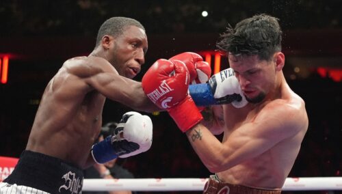Bruce Carrington, left, punches Carlos Castro during a featherweight title boxing match Saturday, Jan. 31, 2026, in New York. (AP Photo/Frank Franklin II)