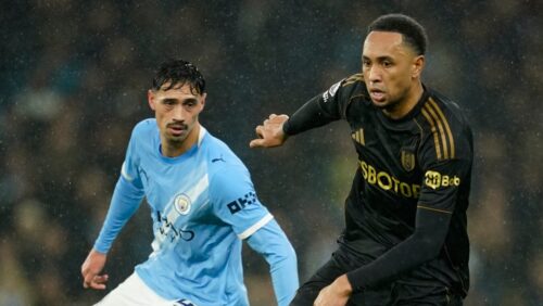 Fulham's Kenny Tete, right, and Manchester City's Tijjani Reijnders challenge for the ball during the English Premier League soccer match between Manchester City and Fulham in Manchester, England, Wednesday, Feb. 11, 2026. (AP Photo/Dave Thompson)