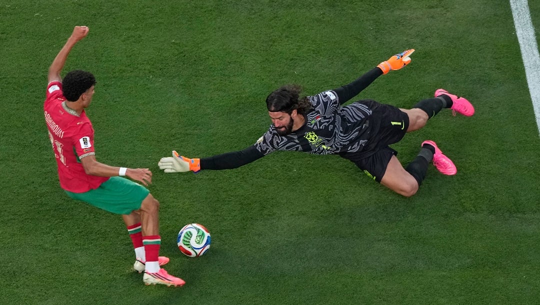 Morocco's Ayoub Amaimouni, left, is unable to score past Brazil goalkeeper Alisson Becker during the World Cup Group C soccer match in East Rutherford, N.J., near New York, Saturday, June 13, 2026. (AP Photo/Matt Slocum)